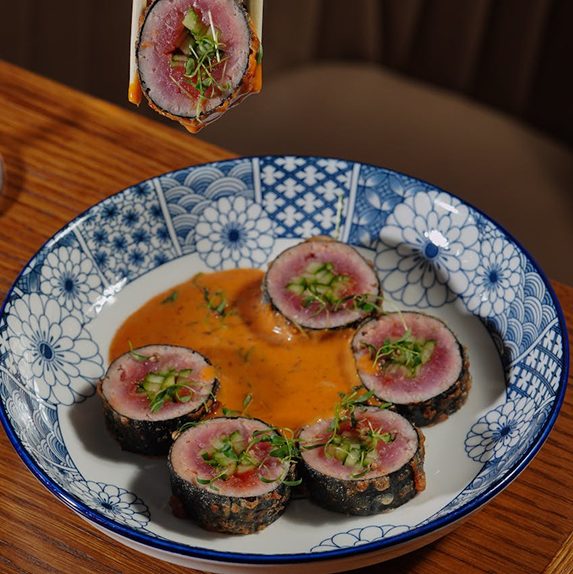 Seared tuna rounds on a blue plate